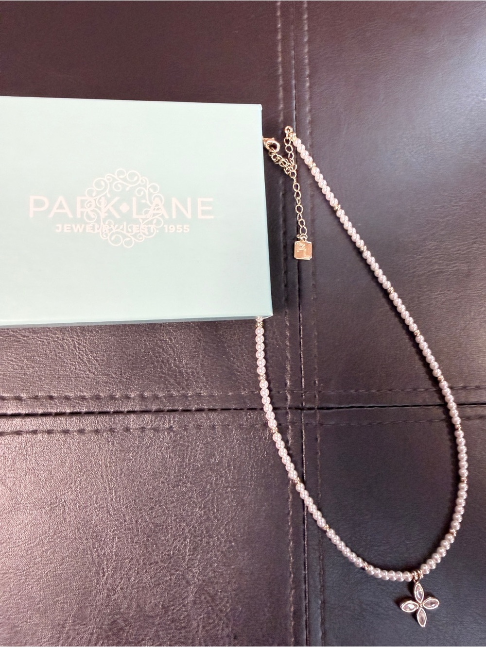 PARK LANE necklace featuring small faux pearls and a four-leaf floral pendant